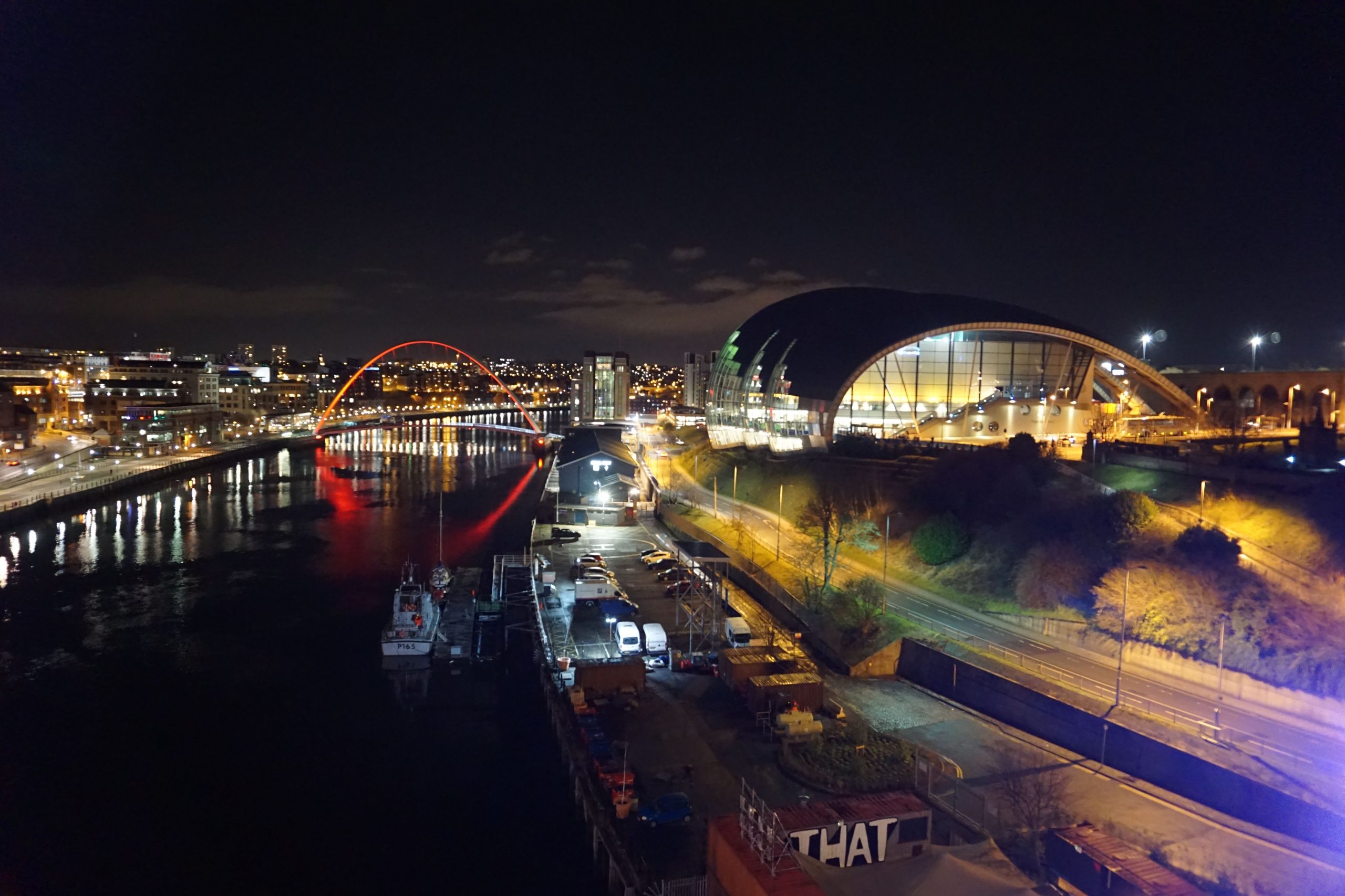 View of River Tyne, Millennium bridge and Gateshead Sage from Tyne Bridge in Newcastle at night.