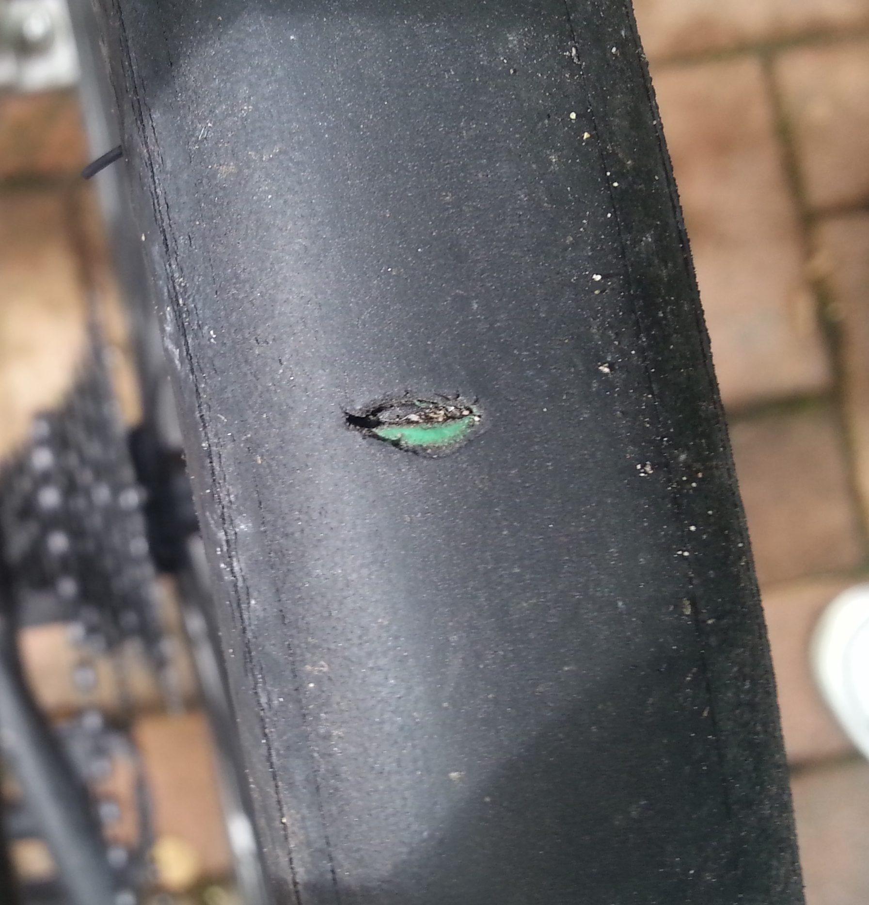 Puncture from sharp gravel cutting through the tire and into the inner tube.